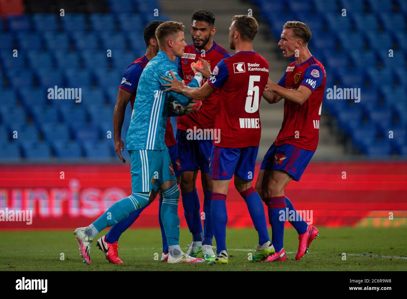 Teammates of goalkeeper Jonas Omlin of FC Basel celebrate with him after  his huge penalty save in the last minute during the Super League football  match between FC Basel 1893 and BSC