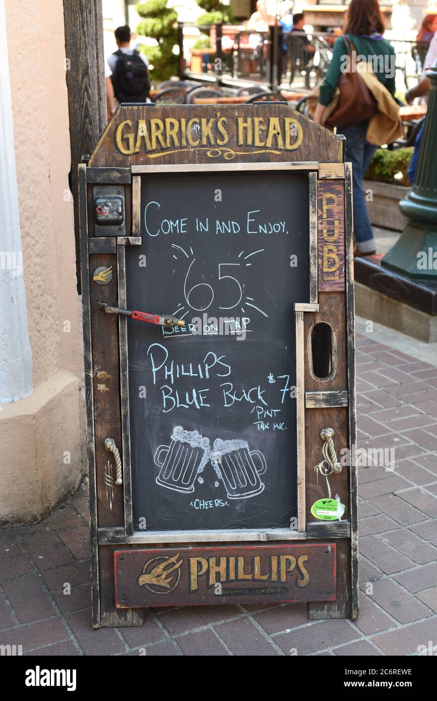 A sign advertising beer from local craft  beer brewery Phillips Brewing stands outside the Garrick’s Head pub and restaurant in downtown Victoria, Bri Stock Photo