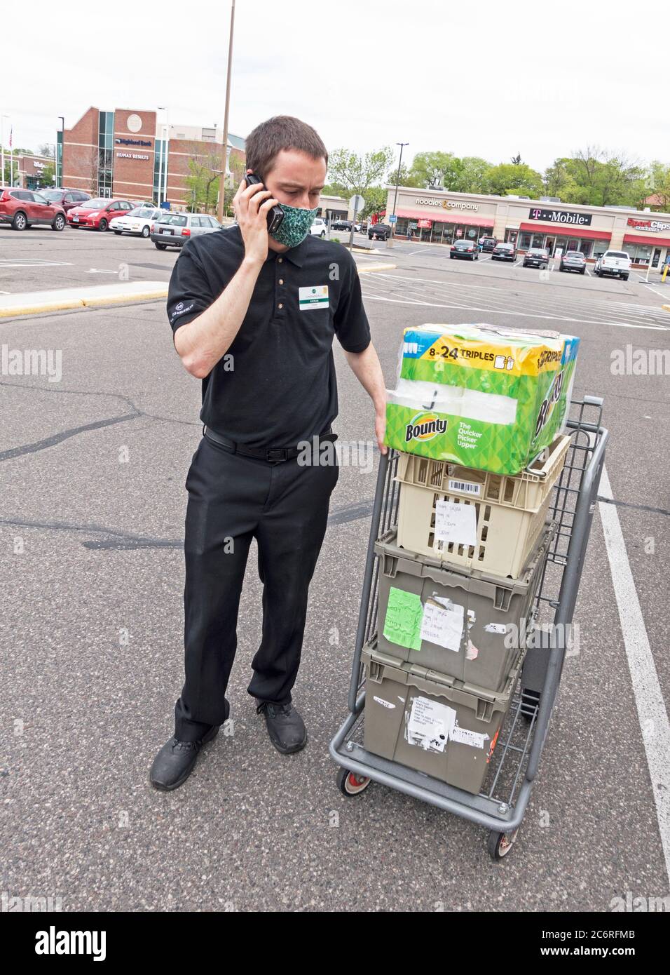 Delivery person scheduling curbside service for groceries at Lunds store. St Paul Minnesota MN USA Stock Photo