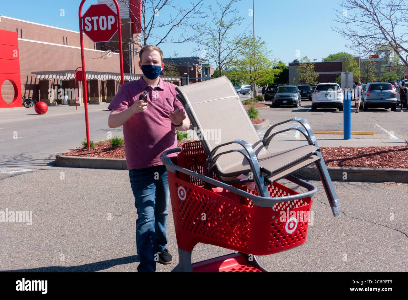 masked worker from target delivering lawn chairs for