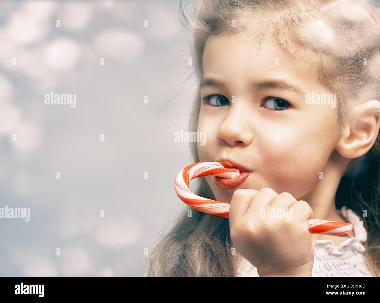 little girl eats a candy bar Stock Photo