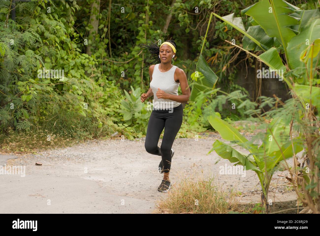 young black runner girl enjoying outdoors jogging workout - young ...