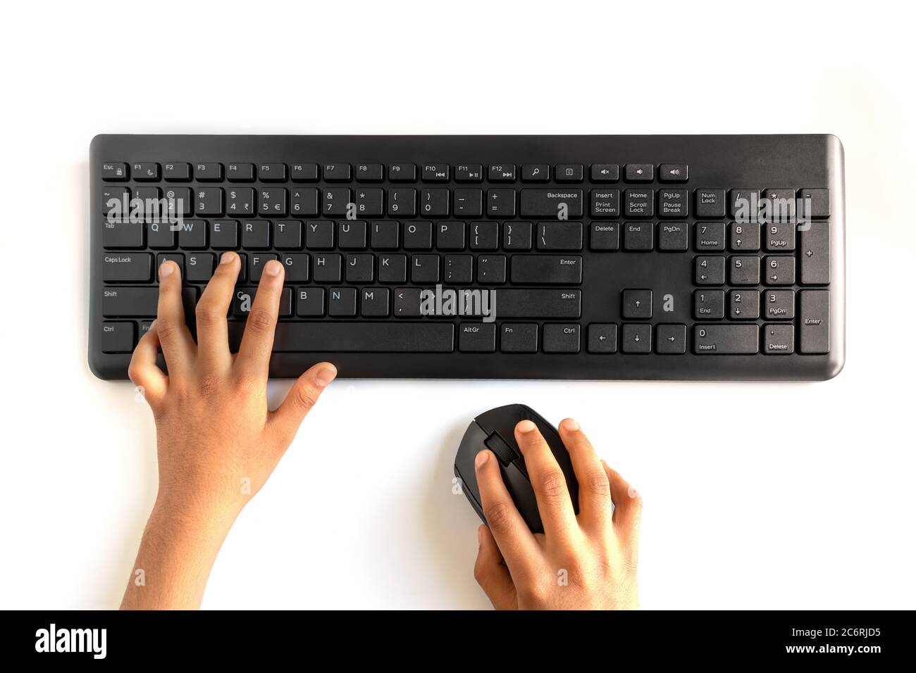 Black Wireless Keyboard and Mouse Isolated on white background. Peron tying and holding mouse in hand. Stock Photo