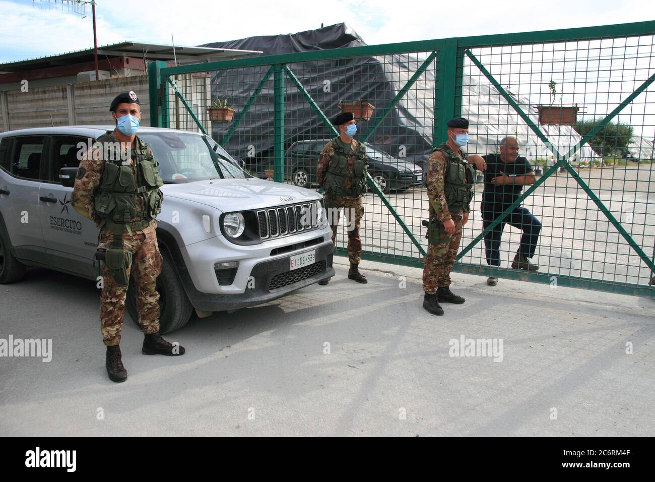 Military Italian army garrison in front of the gate of the waste dump of Taverna del Re , the largest in the Campania region. Stock Photo