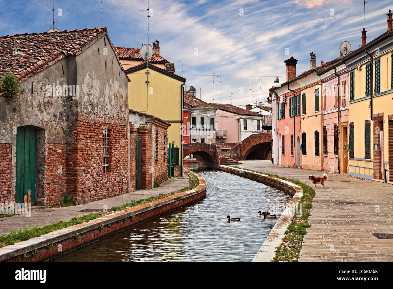 Comacchio, Ferrara, Emilia-Romagna, Italy: cityscape with colorful houses, canal and bridges in the old town known as Little Venice Stock Photo