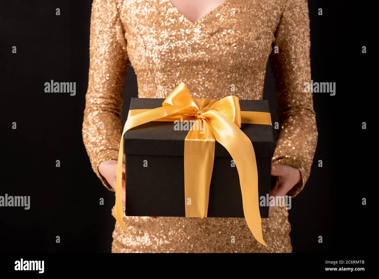 Hands of young elegant female in luxurious dress holding black