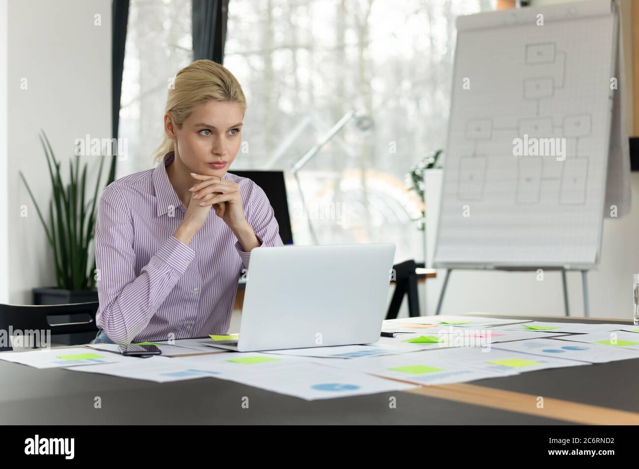 Thoughtful Caucasian businesswoman ponder over report in office Stock Photo