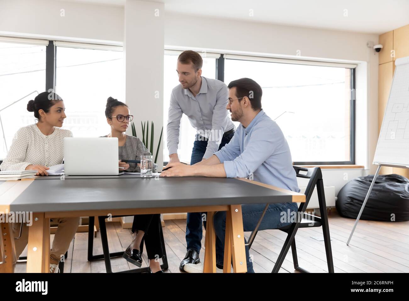 Multiracial colleagues brainstorm work on laptop at meeting Stock Photo ...