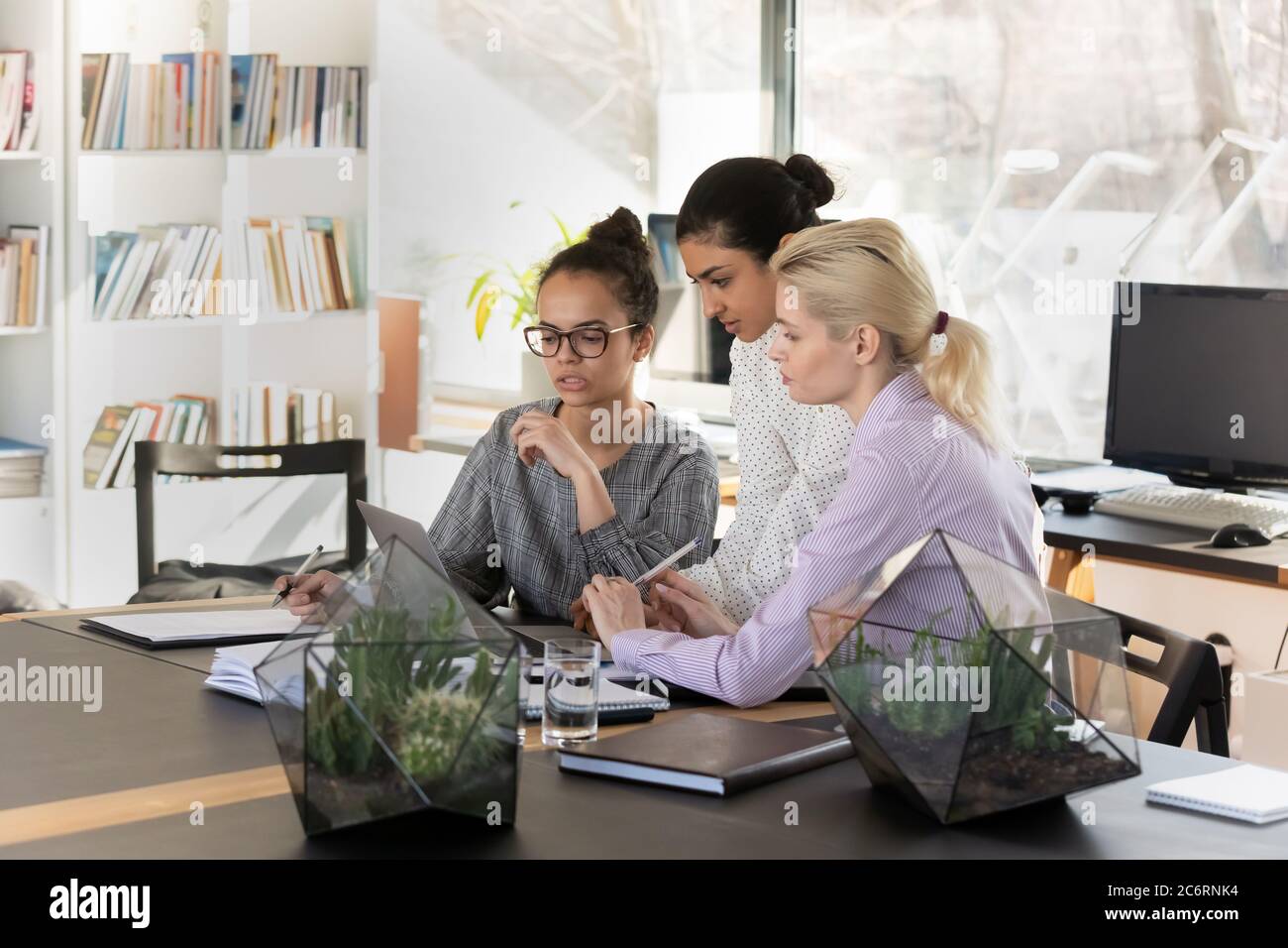 Pensive multiracial female employees work on computer in office Stock ...