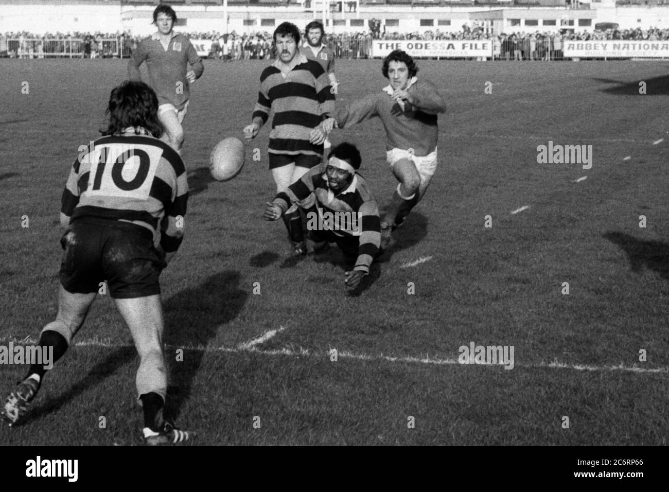 Cardiff RFC's Carl Smith makes a hurried pass to Keith James to clear while under pressure from Llanelli RFC's Selwyn Williams in a WRU Cup fixture at Cardiff Arms Park, Cardiff, Wales on 23 February 1974. Stock Photo