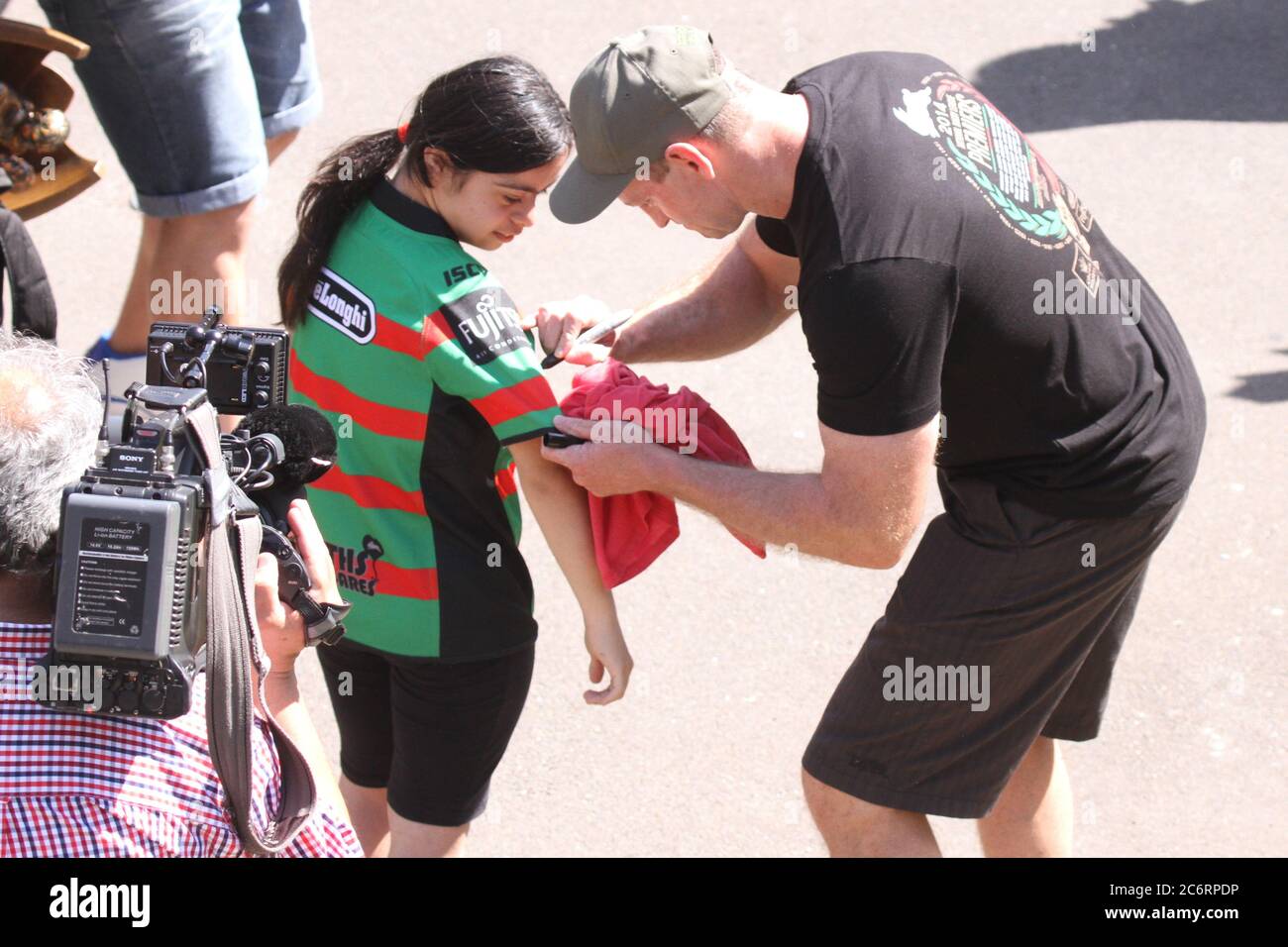 South Sydney Rabbitohs Coach Michael Maguire signs an autograph for a fan as he leaves an event at Redfern Ova celebrating the NRL grand final victory Stock Photo
