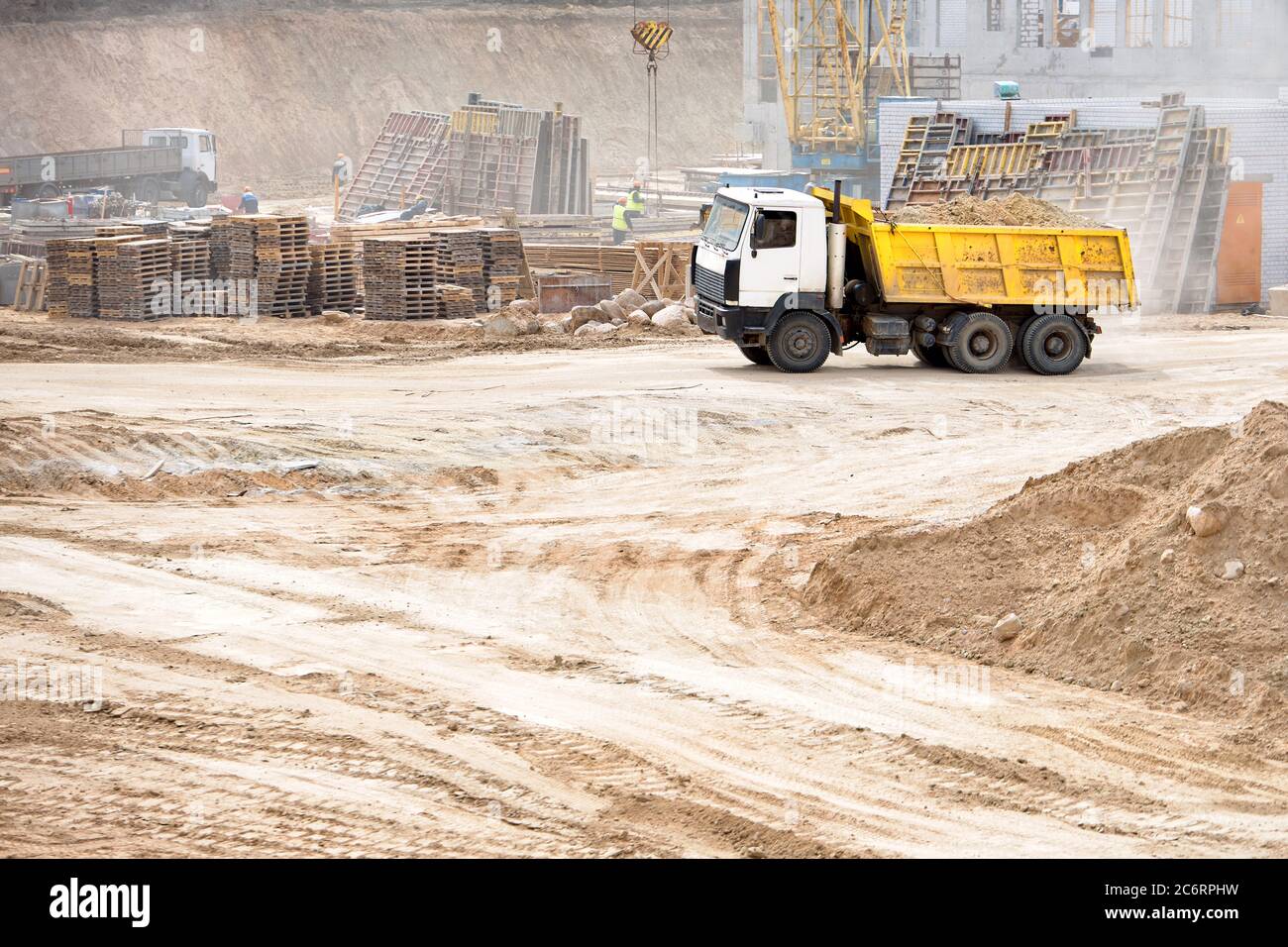 Multi-ton heavy mining dump truck loaded during removal of construction soil from construction site. Concept of providing transport shipping and Stock Photo