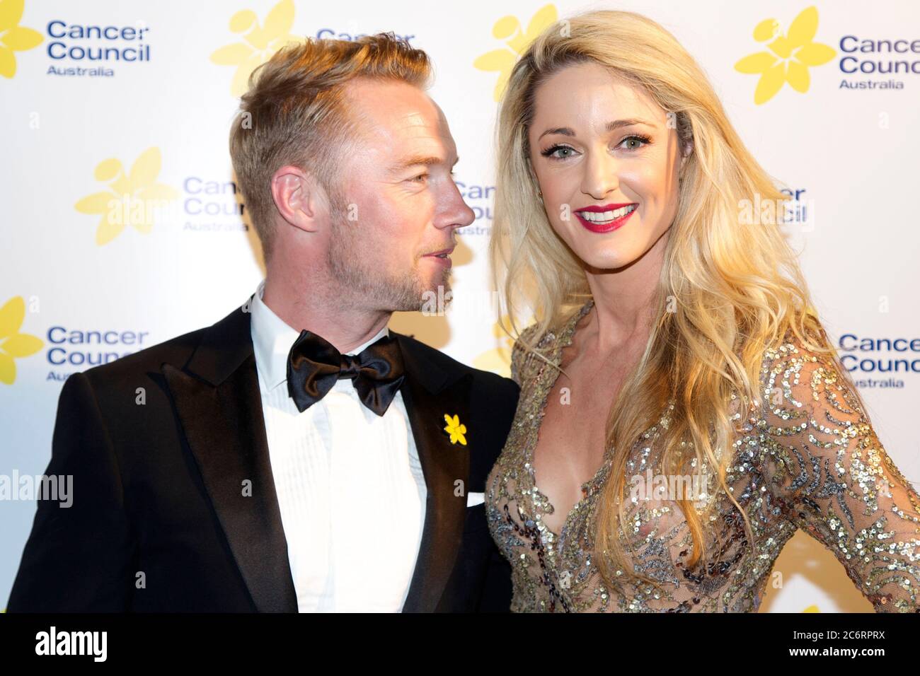 X Factor Australia judge Ronan Keating and Storm Uechtritz arrive on the red carpet for the Emeralds & Ivy Ball 2014 to raise money for Cancer Council Stock Photo