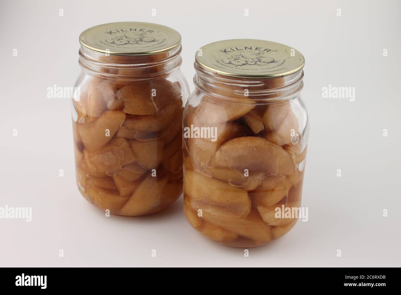 Two glass jars of preserved apples, preserved using the canning method