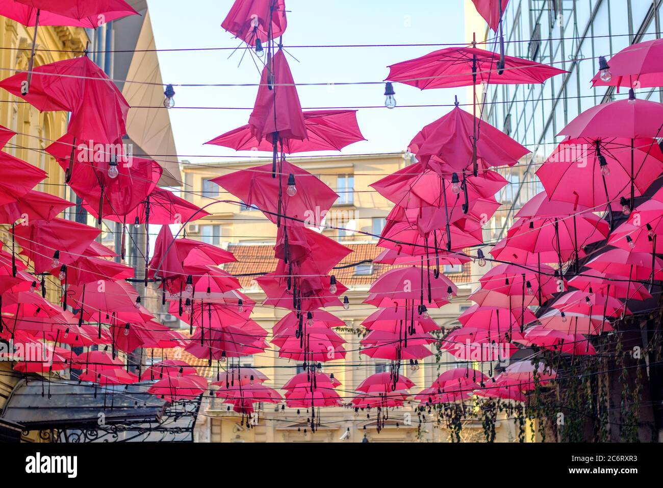 Belgrade / Serbia - December 2, 2018: Red umbrellas above the open-air restaurant in King Peter street, in old bohemian part of Serbian capital Belgra Stock Photo