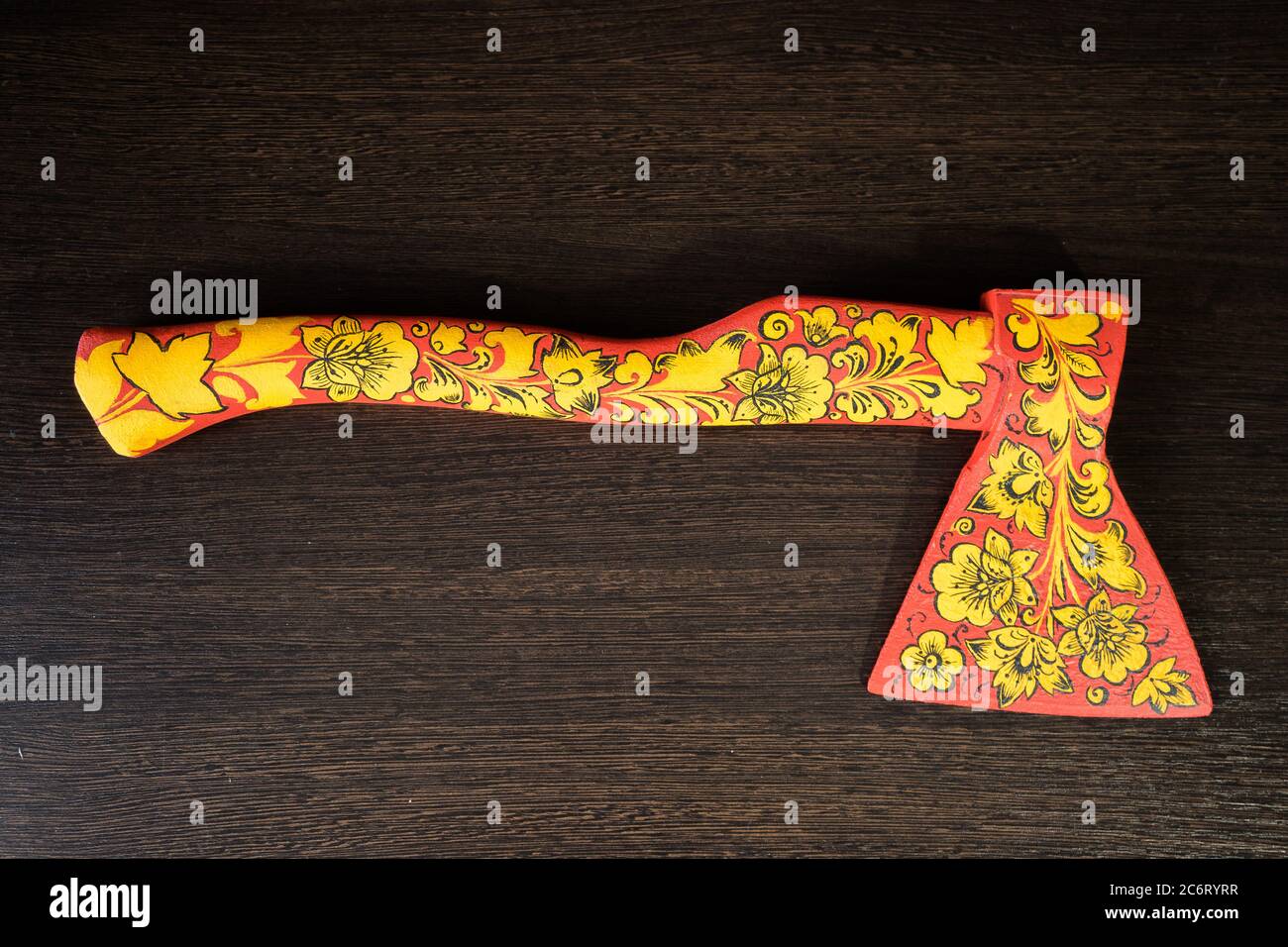 axe in Khokhloma. An axe painted in Russian folk style. Russian