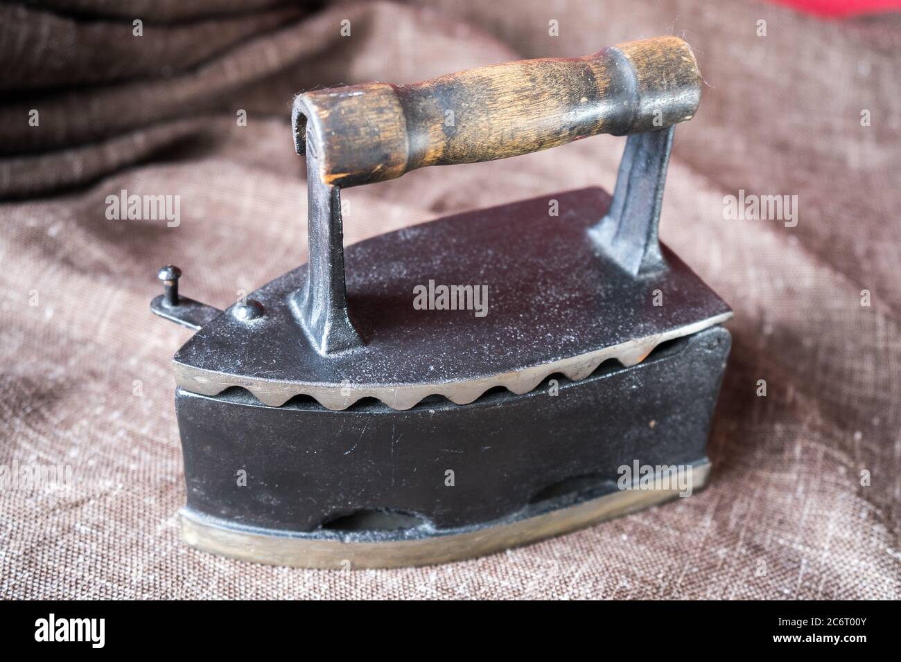 old coal iron. Ancient metal iron on brown canvas Stock Photo Alamy