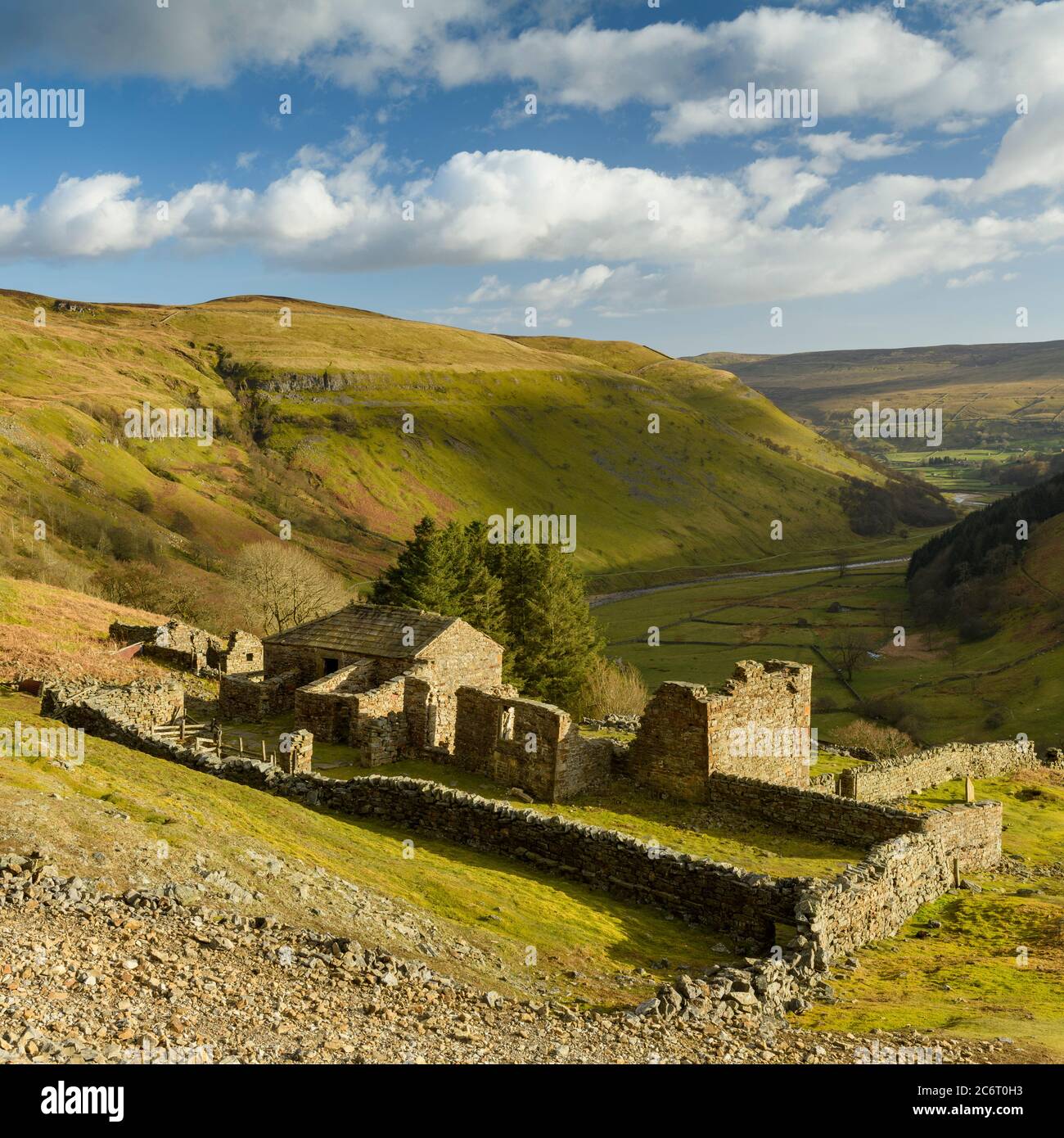 Crackpot Hall (old farmhouse ruins) high on remote sunlit hillside overlooking scenic rural Yorkshire Dales hills & valley (Swaledale) - England, UK. Stock Photo
