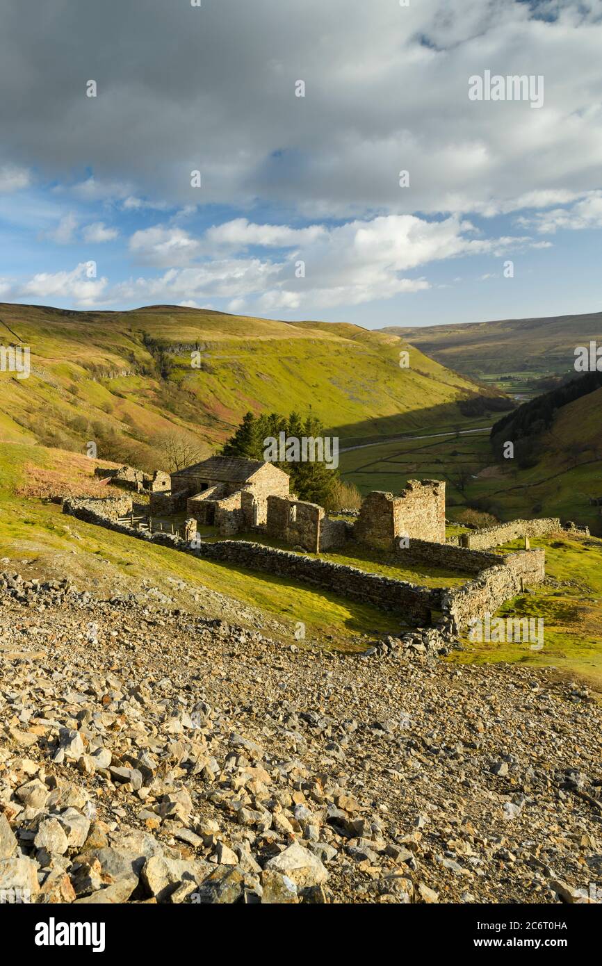 Crackpot Hall (old farmhouse ruins) high on remote sunlit hillside overlooking scenic rural Yorkshire Dales hills & valley (Swaledale) - England, UK. Stock Photo
