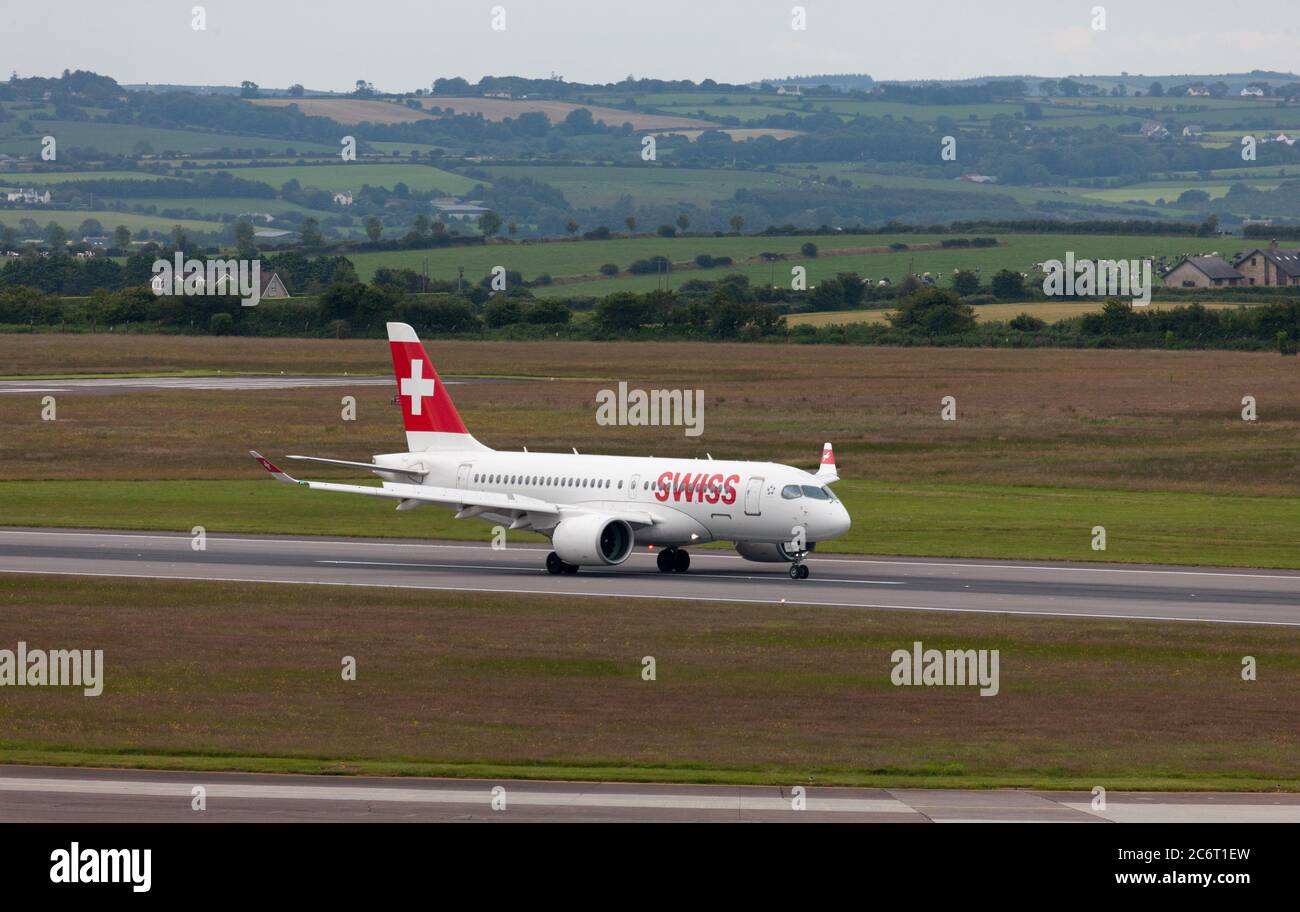 Cork Airport, Cork, Ireland. 12th July, 2020. A Swiss Airbus A220 taxiing to the terminal building on its inaugural weekly service flight from Zurich with 26 passengers at Cork Airport, Cork, Ireland. - Credit; David Creedon / Alamy Live News Stock Photo