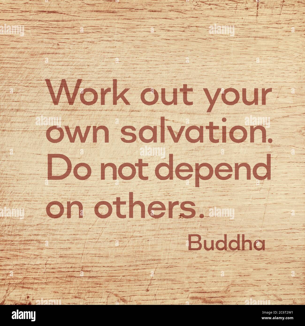 Work out your own salvation. Do not depend on others - famous quote of Gautama Buddha printed on grunge wooden board Stock Photo