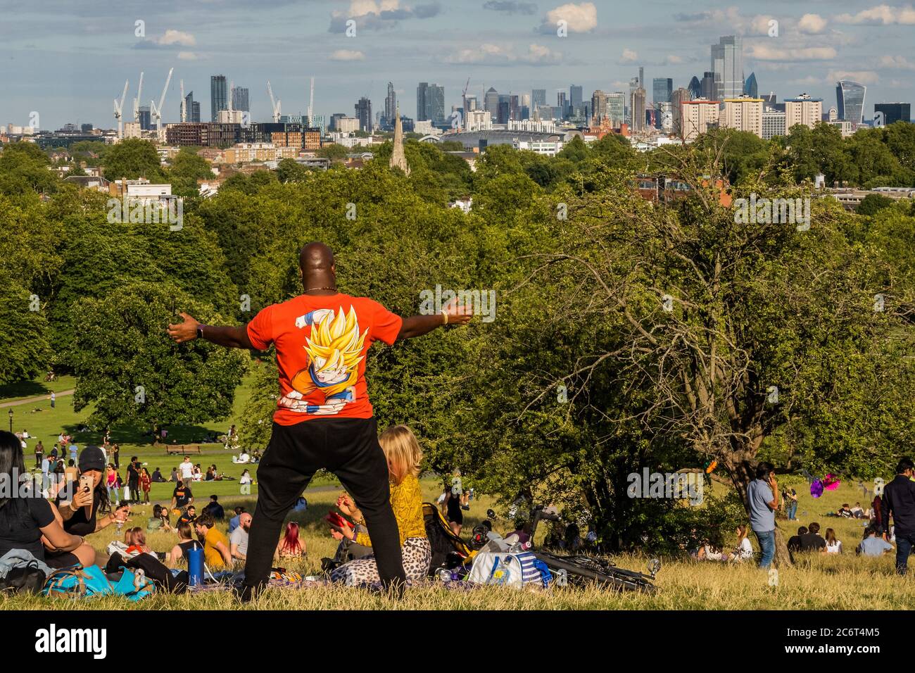 London, UK. 11th July, 2020. People enjoy a sunny evening on Primrose Hill overlooking the city. The 'lockdown' continues to be eased for the Coronavirus (Covid 19) outbreak in London. Credit: Guy Bell/Alamy Live News Stock Photo