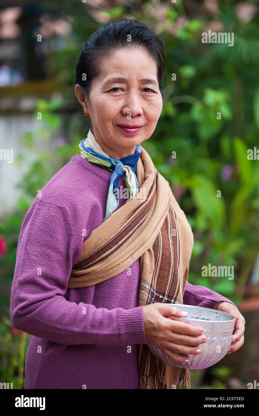 https://c8.alamy.com/comp/2C6T5ED/luang-prabang-laos-november-5-2011-laotian-senior-woman-waiting-to-give-sticky-rice-in-morning-alms-giving-ceremony-to-buddhist-monks-2C6T5ED.jpg