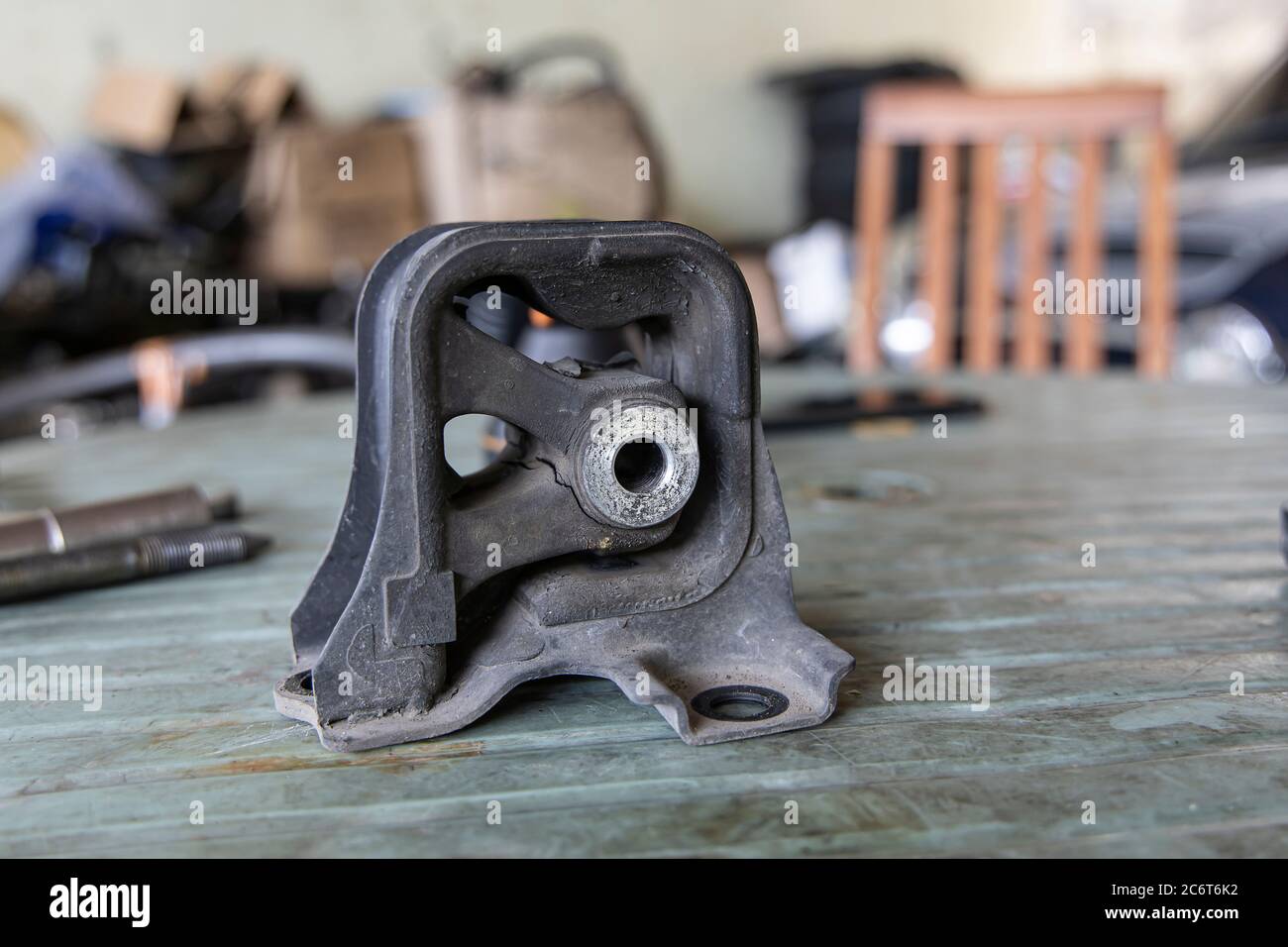 Old rubber engine mount with tools on the table background. Stock Photo