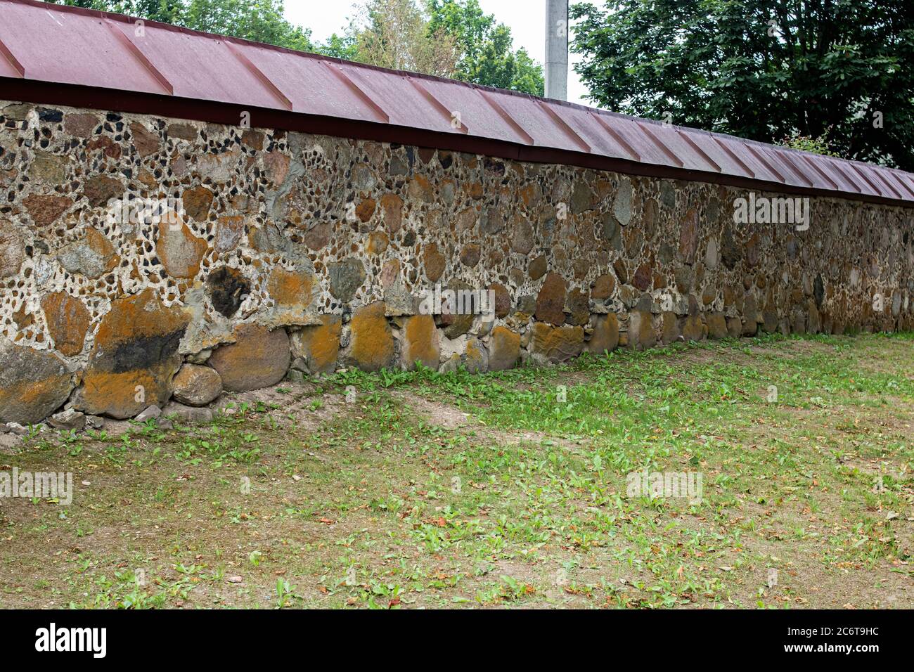 Old stone wall with green garden closeup Stock Photo - Alamy