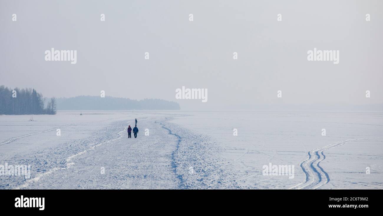 People walking on an ice road , plowed to the lake ice at Winter , Finland Stock Photo