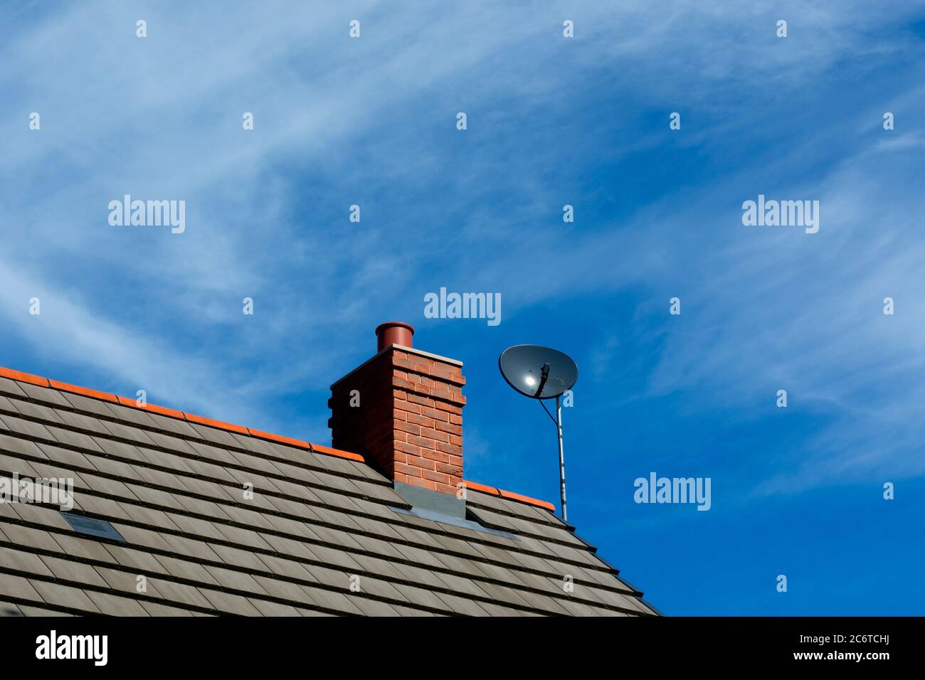 A chimney and satellite dish on a modern house, Warwickshire, UK Stock