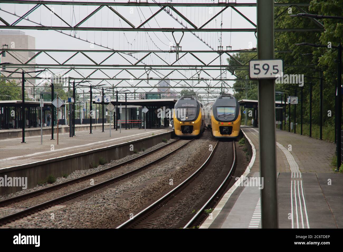 Two VIRM double decks intercity trains along platform of train station Den Haag Laan van NOI