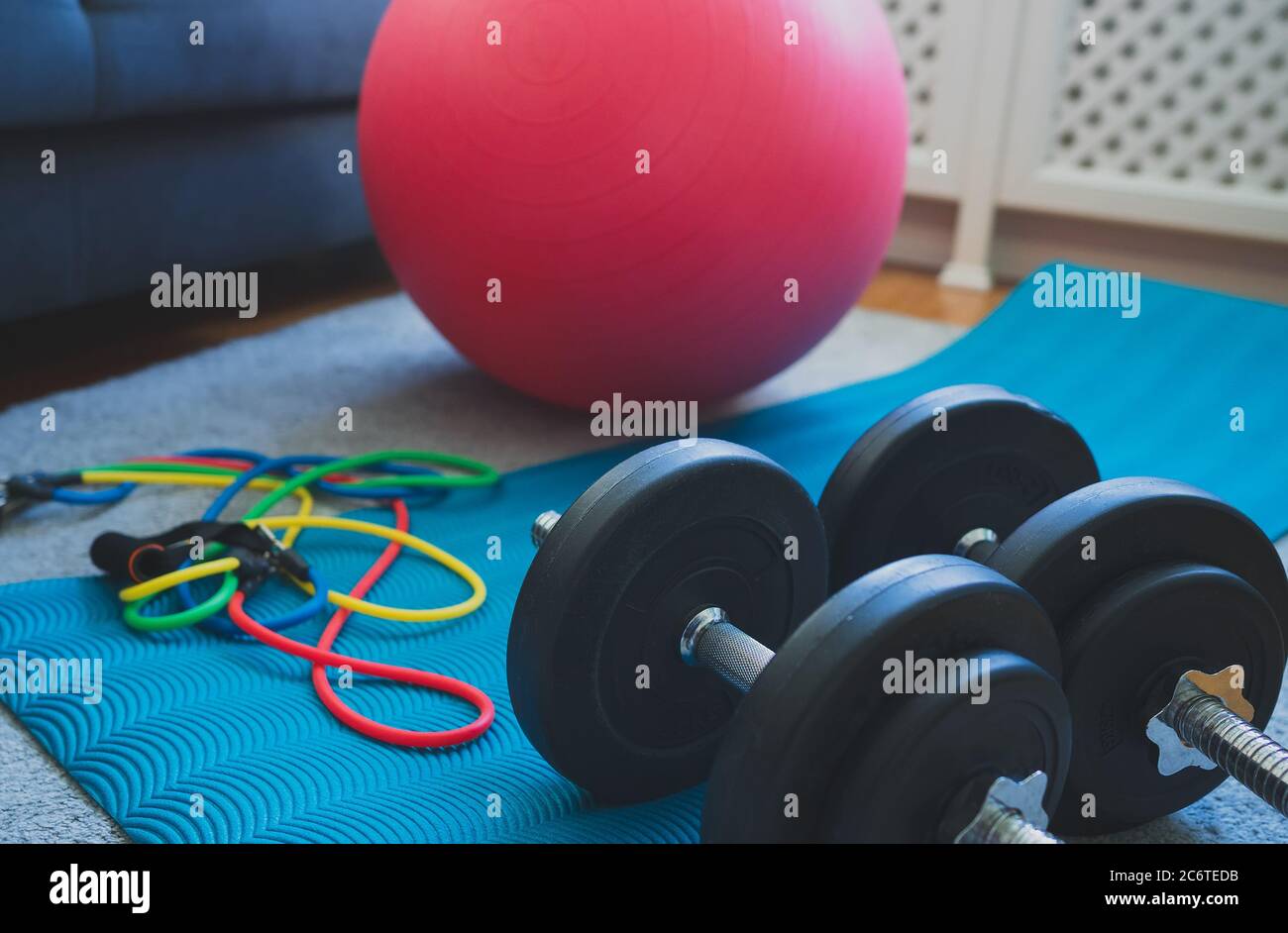 Dumbbells, fitball and resistance bands at home Stock Photo Alamy