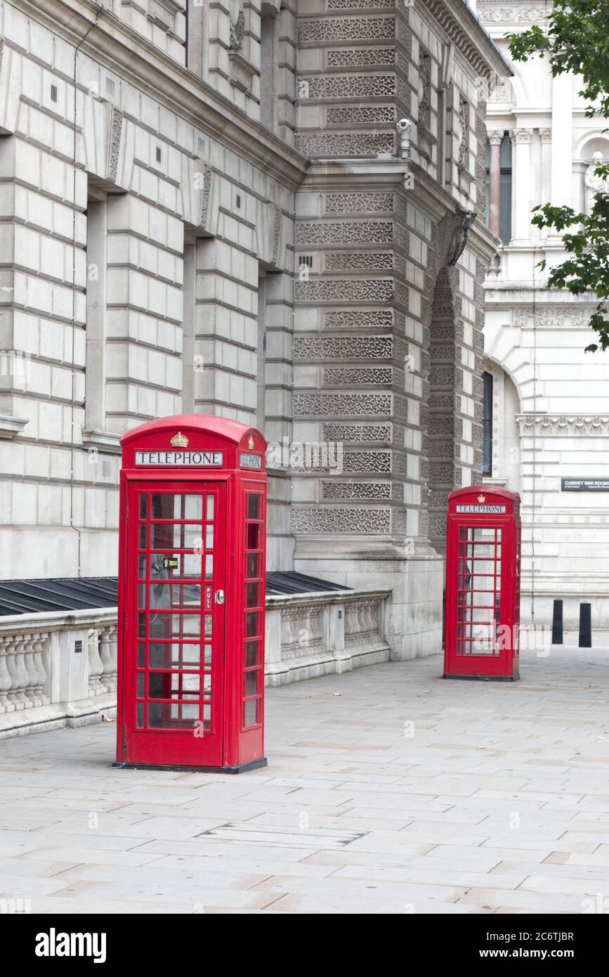 Two traditional iconic red British telephone boxes on Whitehall, London, Stock Photo