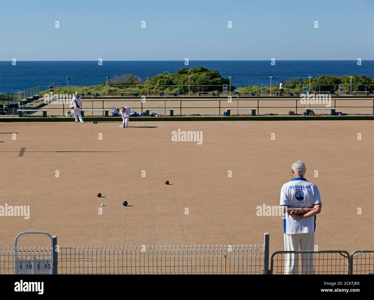 Senior males playing bowls outdoors by the sea on a sunny day at Clovelly, Sydney Stock Photo