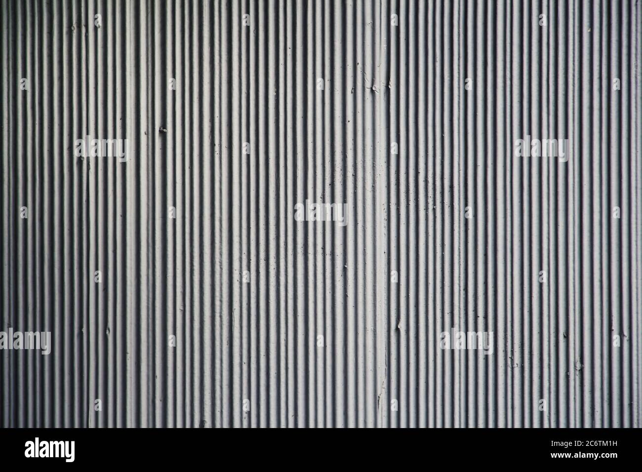 Textured concrete wall with vertical lines in grey as a texture or for ...