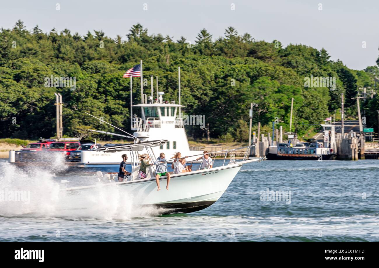 People on a boat with South Ferry in the background, North Haven, NY Stock Photo