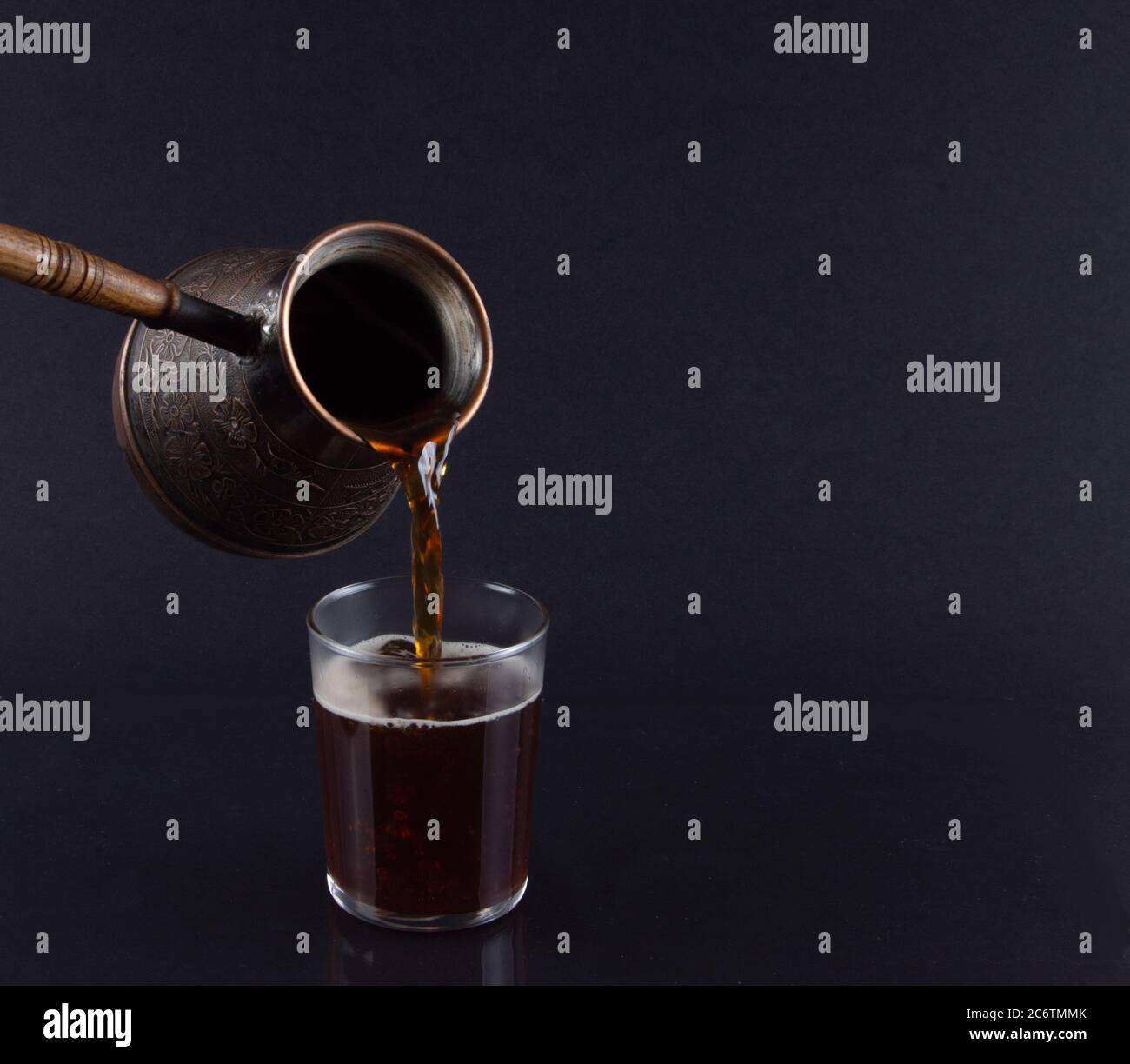 Freshly Brewed Turkish Coffee Poured from Cezve.. Stock Photo