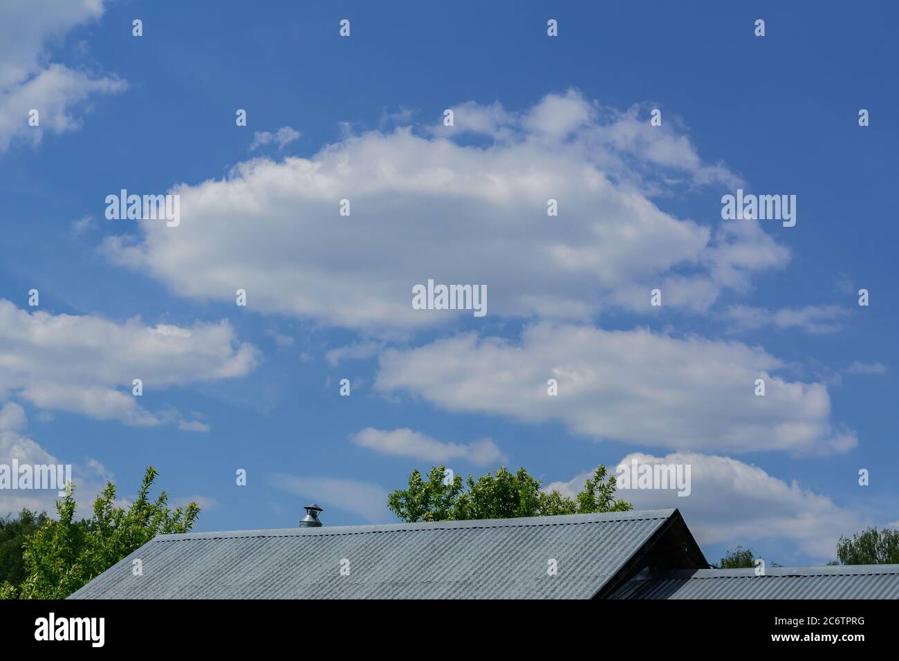 view of roof of the house and blue sky with clouds Stock Photo - Alamy