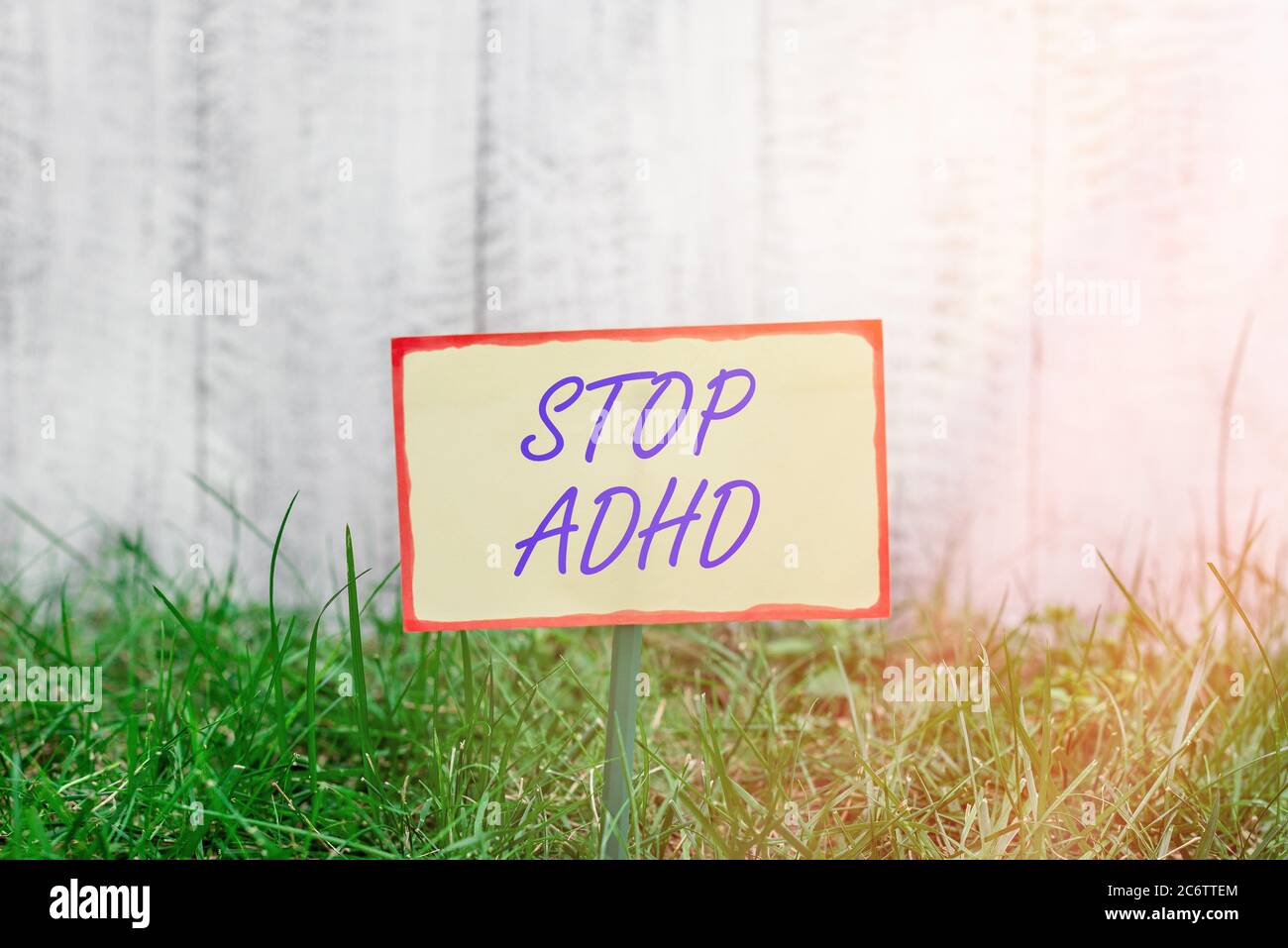 Writing note showing Stop Adhd. Business concept for treat a disorder that affects the brain and behaviors of a child Plain paper attached to stick an Stock Photo