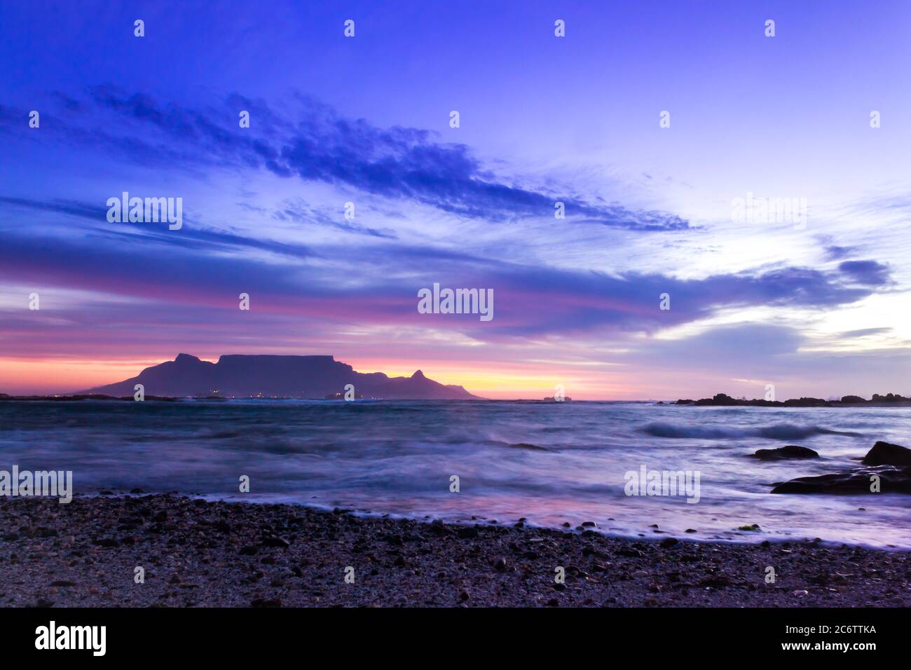 View of Table Mountain at sunrise, Cape Town, South Africa from Milnerton Beach coastline Stock Photo