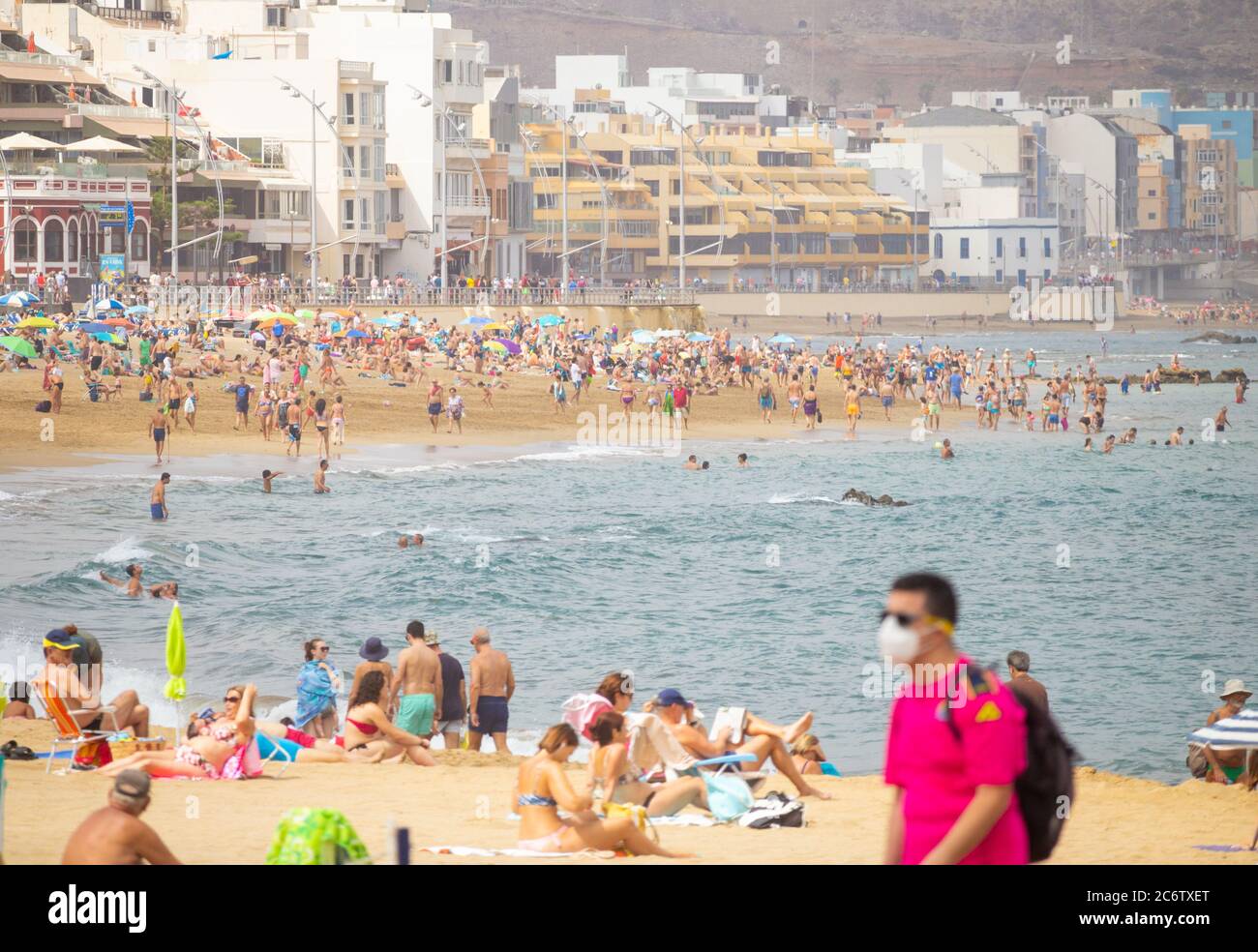Las Palmas, Gran Canaria, Canary Islands, Spain. 12th July, 2020. Loclas  and the odd tourist making the most of an almost tourist free city beach in  Las Palmas on Gran Canaria on