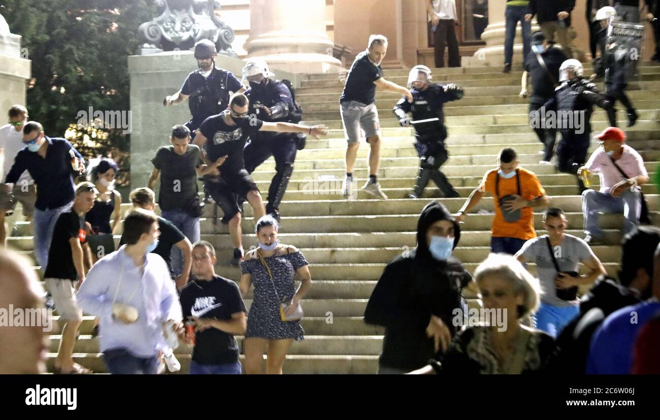 Belgrade, Serbia. 11th July, 2020. Police officers look on during the stand-off with protestors during the protest against the strict measures to fight the coronavirus in Belgrade, Serbia, 11 July 2020. Thousands have gathered in front of the Serbian Parliament in Belgrade to protest the new measures to stem the spread of the SARS-CoV-2 coronavirus, which causes the COVID-19 disease. Credit: Koca Sulejmanovic/Alamy Live News Stock Photo