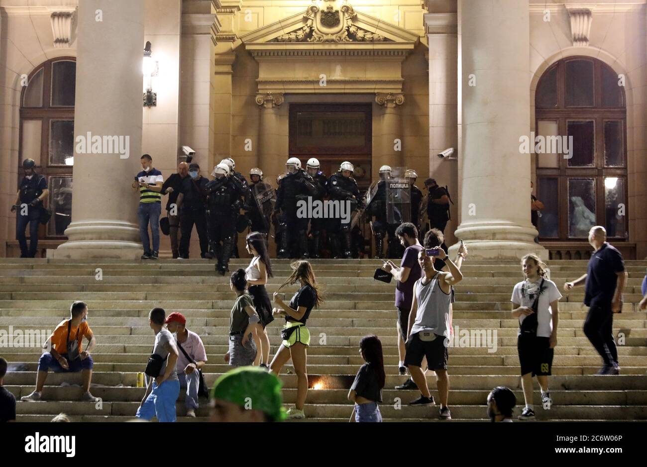 Belgrade, Serbia. 11th July, 2020. Police officers look on during the stand-off with protestors during the protest against the strict measures to fight the coronavirus in Belgrade, Serbia, 11 July 2020. Thousands have gathered in front of the Serbian Parliament in Belgrade to protest the new measures to stem the spread of the SARS-CoV-2 coronavirus, which causes the COVID-19 disease. Credit: Koca Sulejmanovic/Alamy Live News Stock Photo