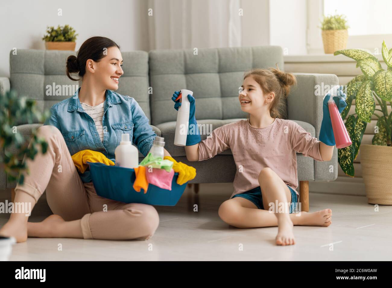 Happy family at home. Mother and daughter doing the cleaning in the ...
