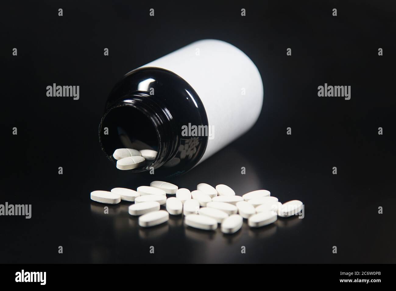 white medicine tablets with black bottle Stock Photo