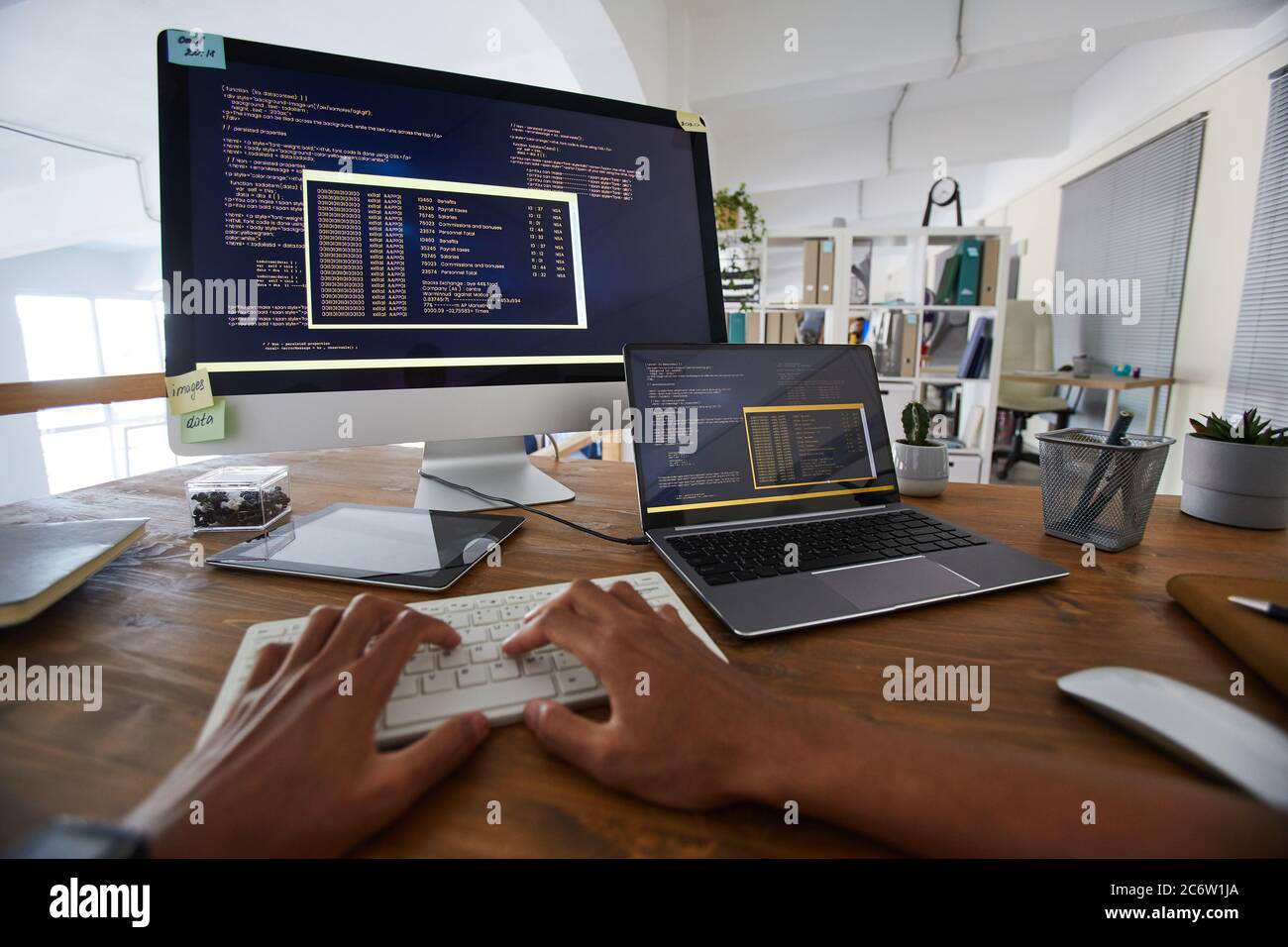 Background image of male hands typing on keyboard with black and orange ...