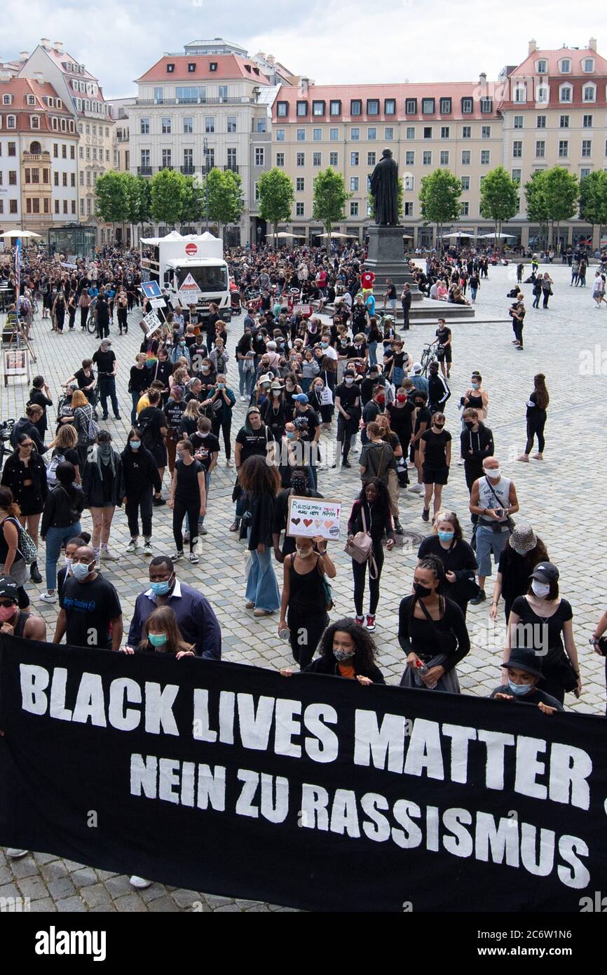 Dresden, Germany. 12th July, 2020. Participants in a demonstration against racism walk across the Neumarkt with a banner. The rally of the 'Black Lives Matter Dresden' - group wants to draw attention to structural racism after the violent death of George Floyd. Credit: Sebastian Kahnert/dpa-Zentralbild/dpa/Alamy Live News Stock Photo