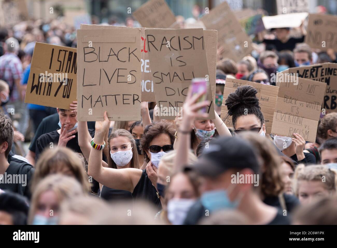 Dresden, Germany. 12th July, 2020. Participants of a demonstration against racism hold various signs and banners on the Neumarkt. The rally of the 'Black Lives Matter Dresden' - group wants to draw attention to structural racism after the violent death of George Floyd. Credit: Sebastian Kahnert/dpa-Zentralbild/dpa/Alamy Live News Stock Photo