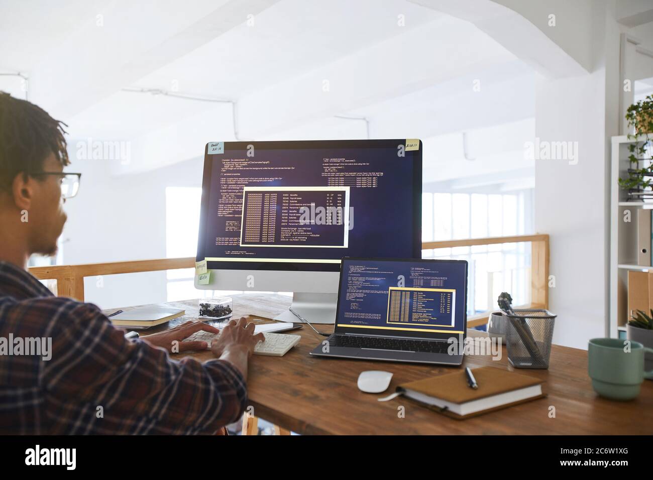 Portrait of African-American IT developer typing on keyboard with black ...